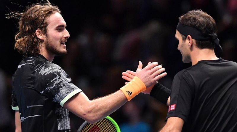 Tsitsipas greets Federer at the net following his semifinal victory over the 20-time Grand Slam winner