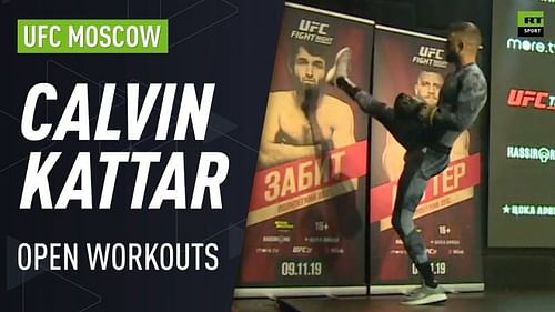 Kattar pretends to kick a backdrop display with Magomedsharipov's face on it