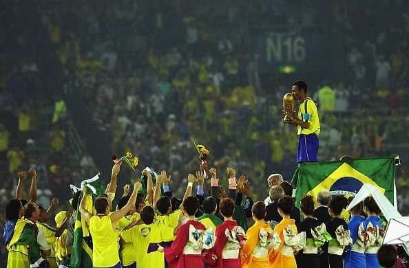 Cafu on the podium celebrates with the World Cup trophy