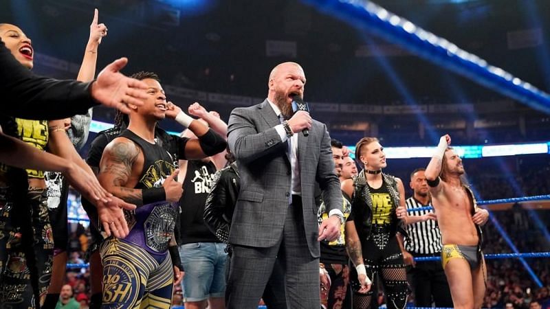 Triple H stands tall with the NXT Superstars in the middle of the ring towards the end of the show