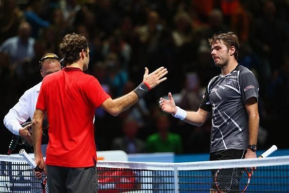 Roger Federer and Stanislas Wawrinka meet at the net