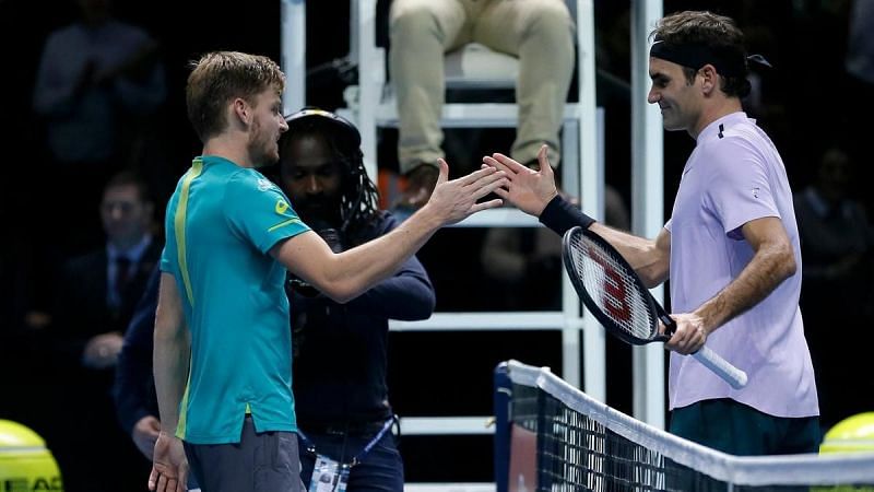 Federer greets Goffin at the net after his semifinal loss to the Belgian