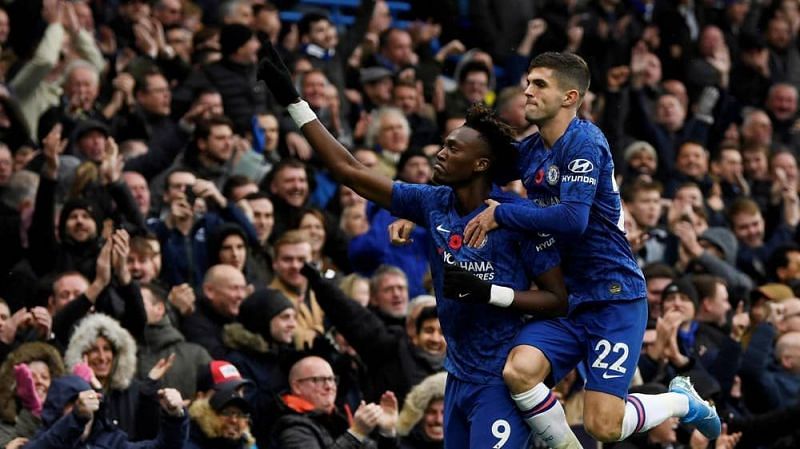 Abraham and Pulisic celebrate Chelsea&#039;s opening goal.