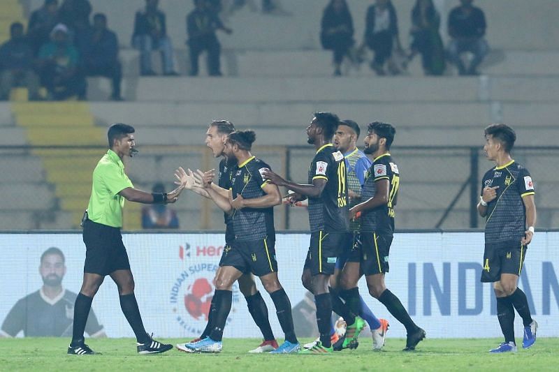 Hyderabad FC players complain to the referee after he wrongly gives a penalty to ATK