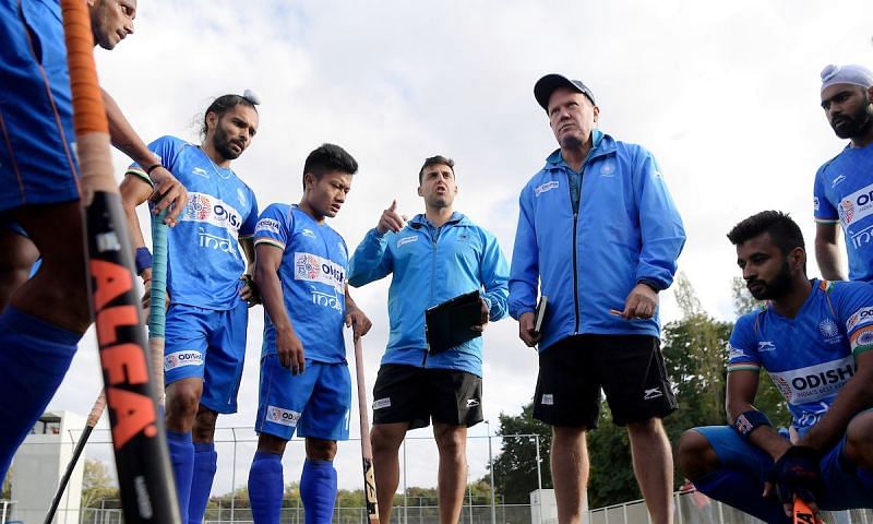 Analytical Coach Chris Ciriello and Graham Reid with the Indians in a huddle