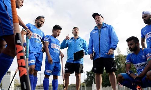 Analytical Coach Chris Ciriello and Graham Reid with the Indians in a huddle