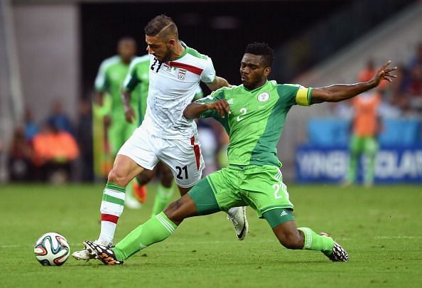 Joseph Yobo makes a sliding tackle at the 2014 World Cup