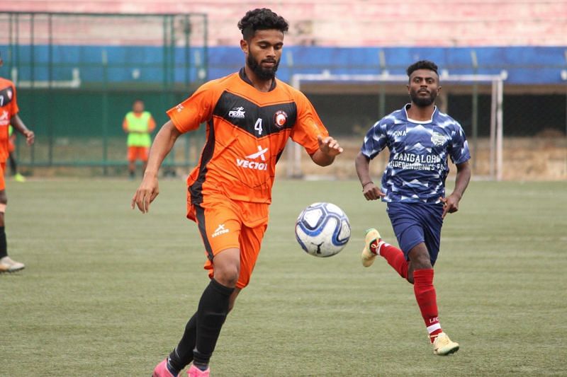 Substitute Nidhin protects the ball for South United FC