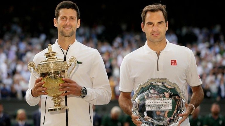 Djokovic (lef) poses with Federer following a pulsating 2019 Wimbledon final