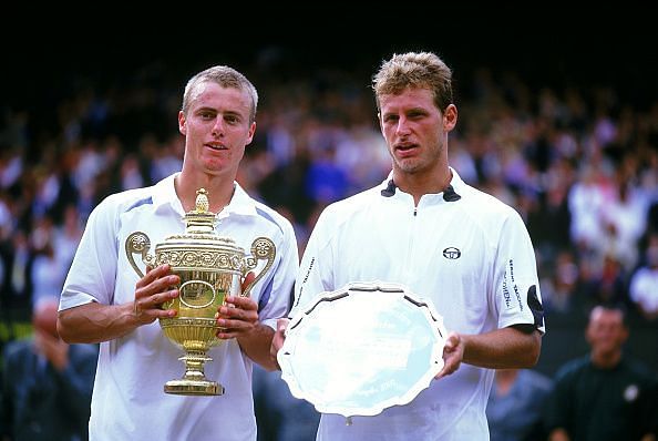 Lleyton Hewitt (L) with the 2002 Wimbledon trophy