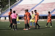 South United FC players in conversation with the referee