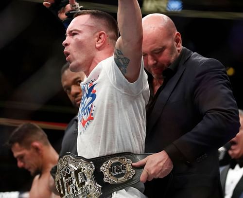 Dana White wrapping the interim UFC Welterweight Title around Colby Covington's waist