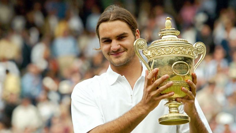 Federer hoists aloft his first Grand Slam title on the grasscourts of Wimbledon in 2003