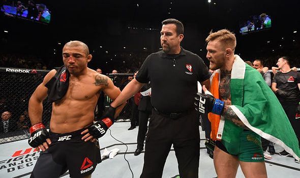 Conor McGregor (right) confronting Jose Aldo at UFC 194