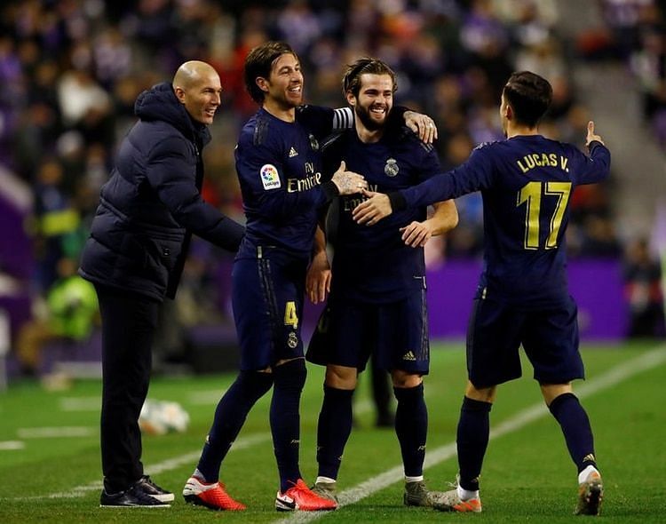 Nacho celebrates with captain Ramos, Lucas Vazquez and Zidane on the touchline