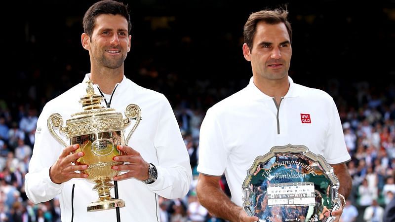 Djokovic (right) holds aloft his 5th Wimbledon title