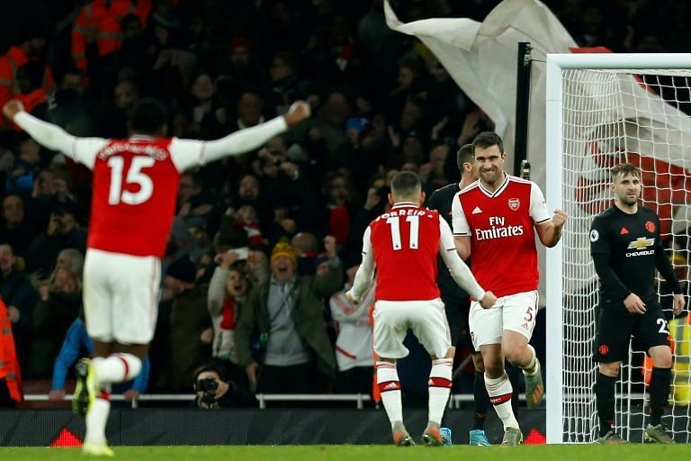 Arsenal players celebrate Sokratis&#039; goal to double their lead against Manchester United