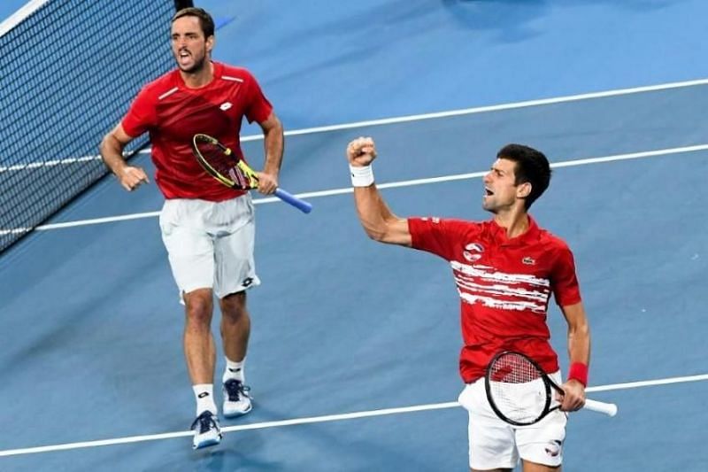 Viktor Troicki (left) rejoices with teammate Novak Djokovic after beating Spain in the final