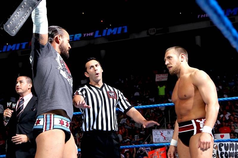 CM Punk (left) posing with the WWE Title against Daniel Bryan