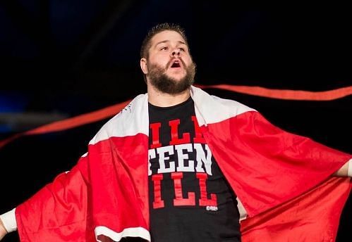 Kevin Owens with a Canadian flag wrapped around him