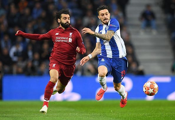 Telles competes with Salah for possession
