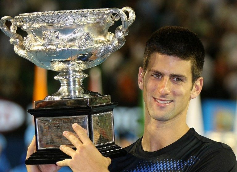 Novak Djokovic hoists aloft his maiden Grand Slam title at the 2008 Australian Open