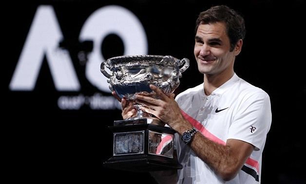 Federer hoists aloft his 20th Grand Slam title at the 2018 Australian Open