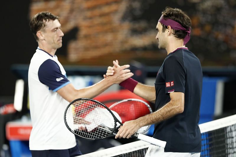 John Millman (L) and Roger Federer