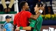 Monfils (right) greets Djokovic at the net following their semifinal