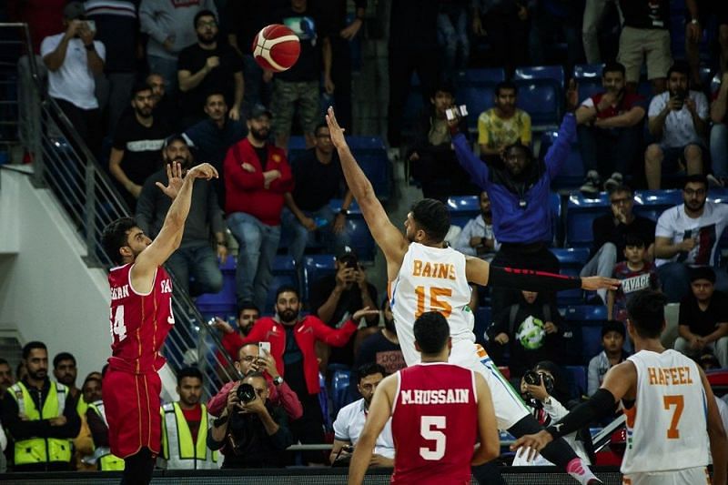 Bahrain&#039;s Hesham Sarhan with the game-winning three over India&#039;s Jagdeep Bains. Image credit: FIBA.com