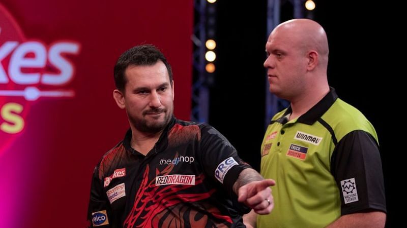 Michael van Gerwen (R) was toppled by Jonny Clayton in the first tournament of this season.