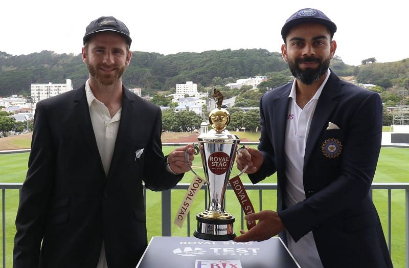 Virat Kohli and Kane Williamson pose with the coveted trophy.