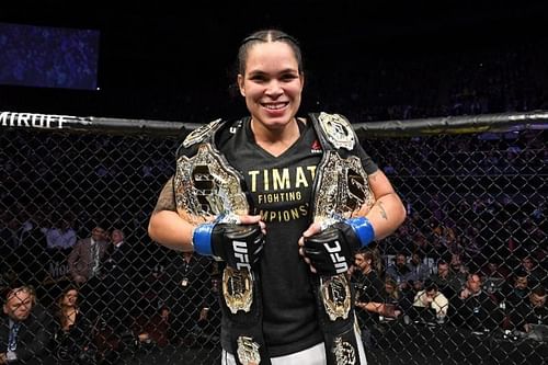 Amanda Nunes with her two Championship belts