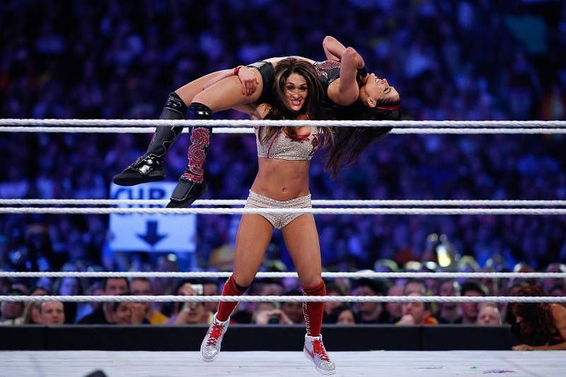 Nikki beats Brie in the age department.