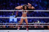 Nikki beats Brie in the age department.