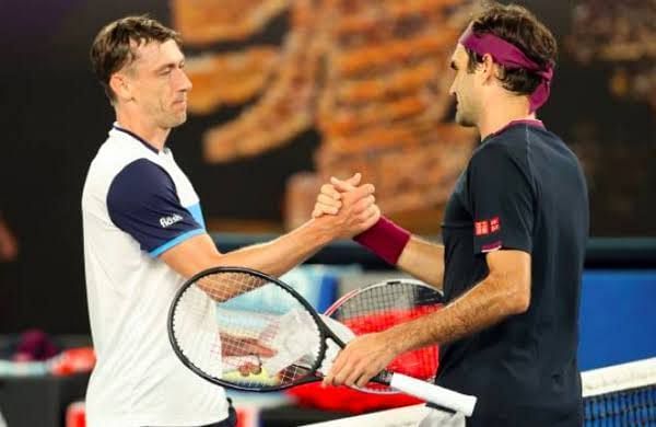 Federer greets Millman following the pair&#039;s third round match