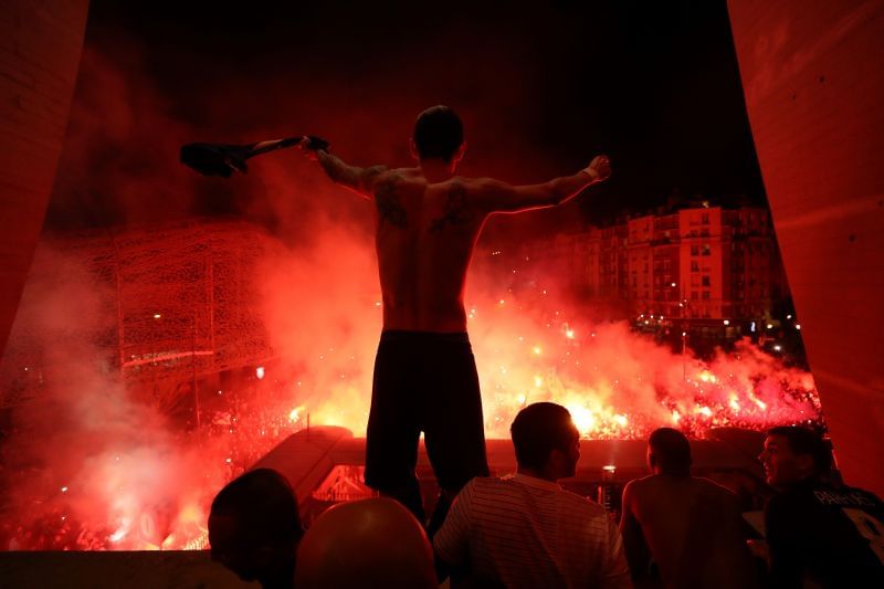 di Maria celebrates with jubilant fans post-match after the game had to be played behind closed doors