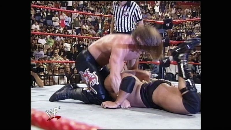 Triple H devastates the Rock with his Pedigree finisher.
