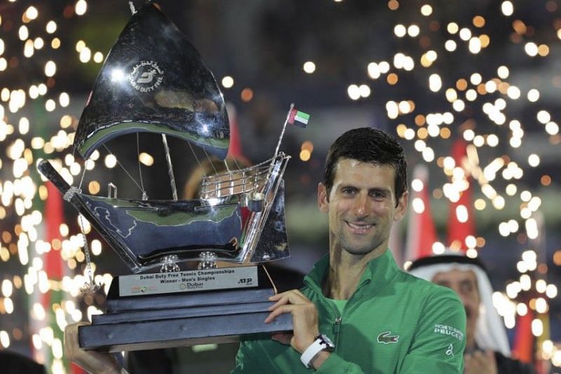 Djokovic hoists aloft his 5th Dubai Open title in 2020.