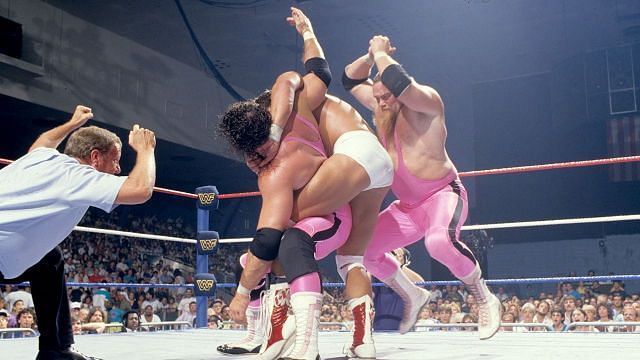 Trapped in an abdominal stretch, Bret Hart is rescued by partner Jim Neidhart
