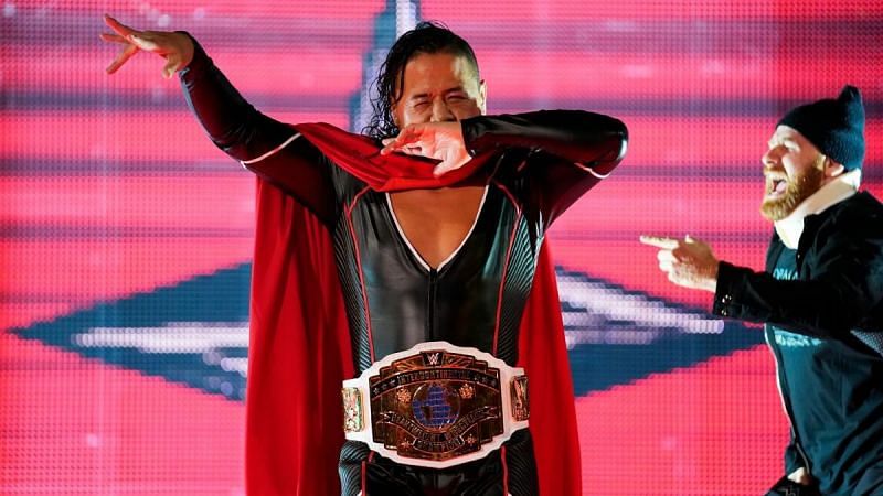 Shinsuke Nakamura (left) as the WWE Intercontinental Champion