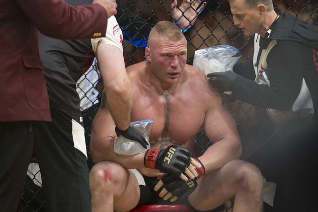 Brock Lesnar receives attention during a break between rounds