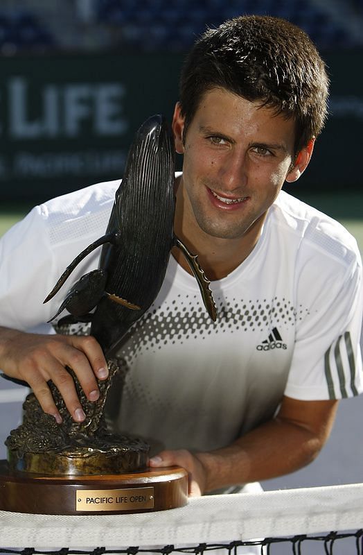 Djokovic poses with his first Indian Wells title in 2008.