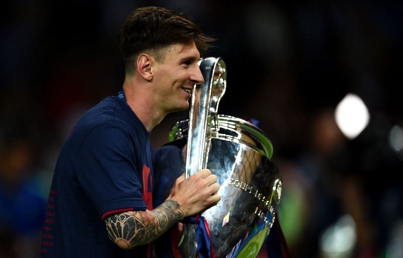 Lionel Messi poses with the UEFA Champions League trophy