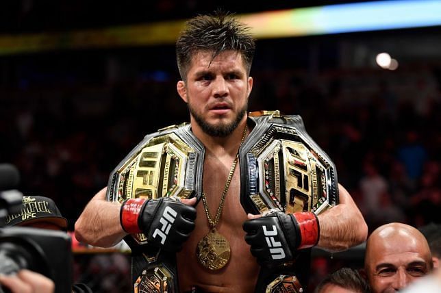 Henry Cejudo with his two Championship belts