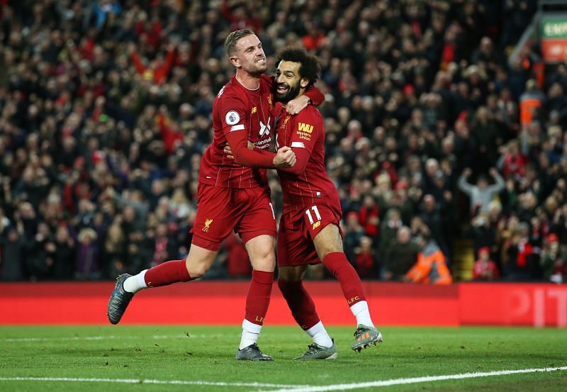 Salah celebrates with Jordan Henderson after scoring the winner against Tottenham