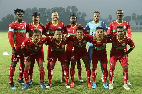 Angousana poses for the team photograph of TRAU FC in front row donning the #8 jersey