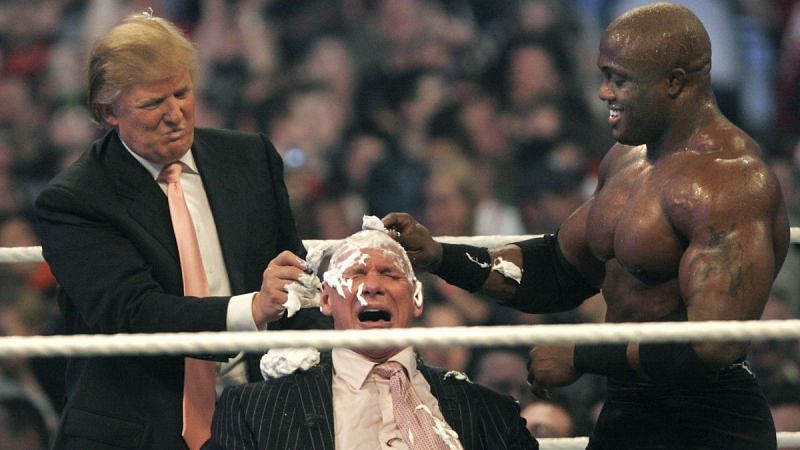 Donald Trump shaving the head of Vince McMahon with the help of Bobby Lashley