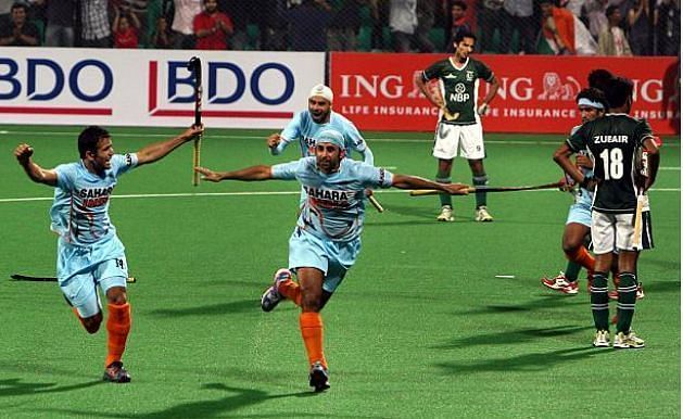 Prabhjot Singh celebrates with his team mates after scoring against Pakistan in India's first world cup match.