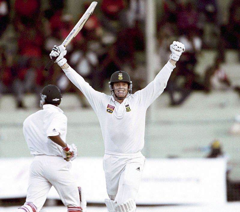 Shaun Pollock celebrates after completing his hundred.